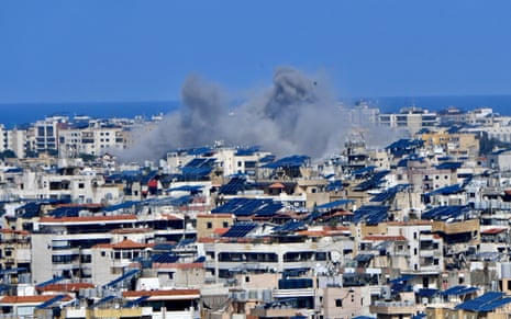 Smoke rises among the residential buildings following Israeli airstrikes on Dahiyeh, a southern suburb of Beirut.