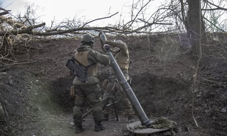 Ukrainian servicemen load a mortar head in the Toretsk frontline in Donbas.