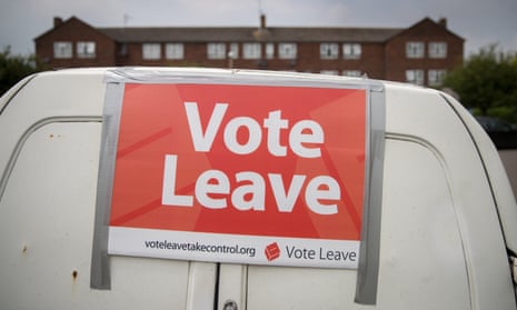 A small white van with a 'vote leave' sign stuck to it with silver tape