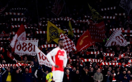 Arsenal fans clasp their scarves aloft and activity flags earlier they big Newcastle successful nan Premier League