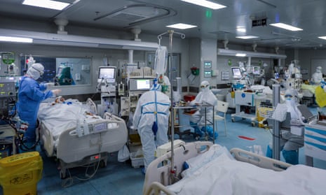 Medical personnel work in the intensive care unit (ICU) of a hospital designated for COVID-19 patients in Wuhan, Hubei province, China