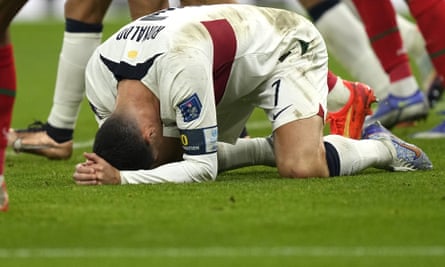 Cristiano Ronaldo sinks to the turf after missing a chance against Morocco.