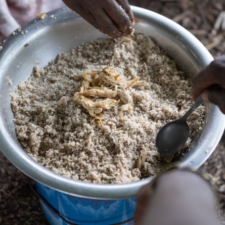 A bowl of small grains with bits of meat