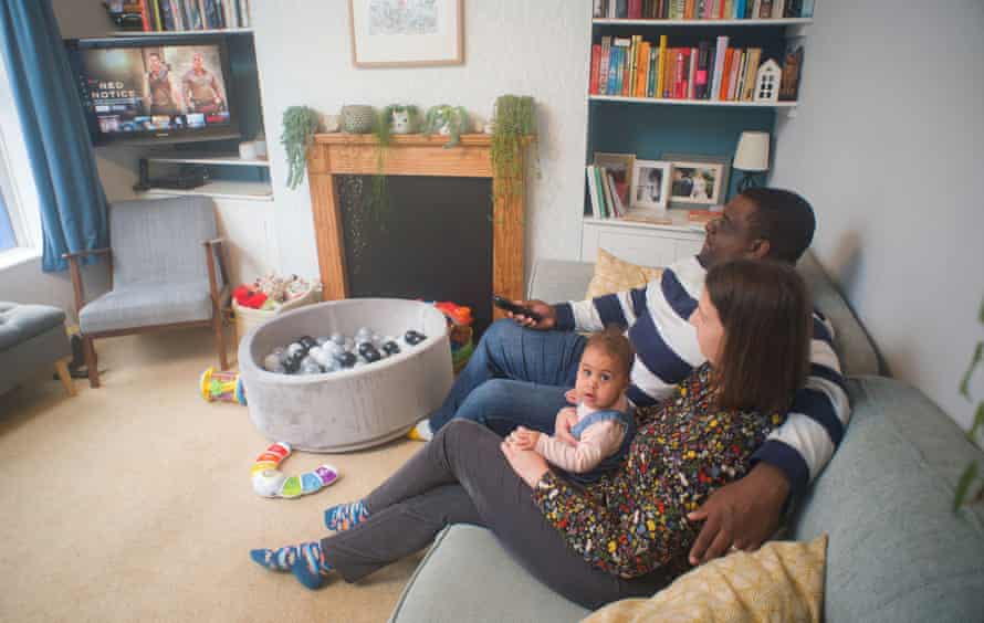 Jonathan &amp; Jess Daly with baby Robyn at home in Norwich, UK. Image shows family watching Netflix.