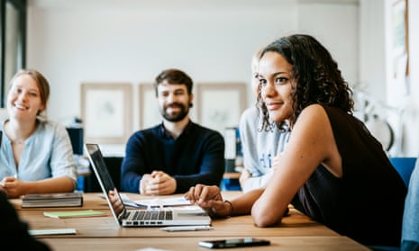 Start up business people during a kick off meeting sitting on a big conference table and listening
