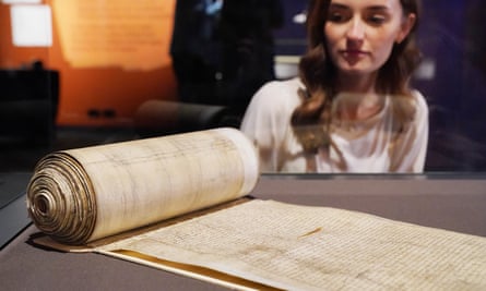 A member of staff looks at the original Treason Act of 1352.