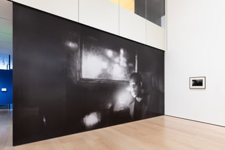 room with large black and white photograph showing man’s face