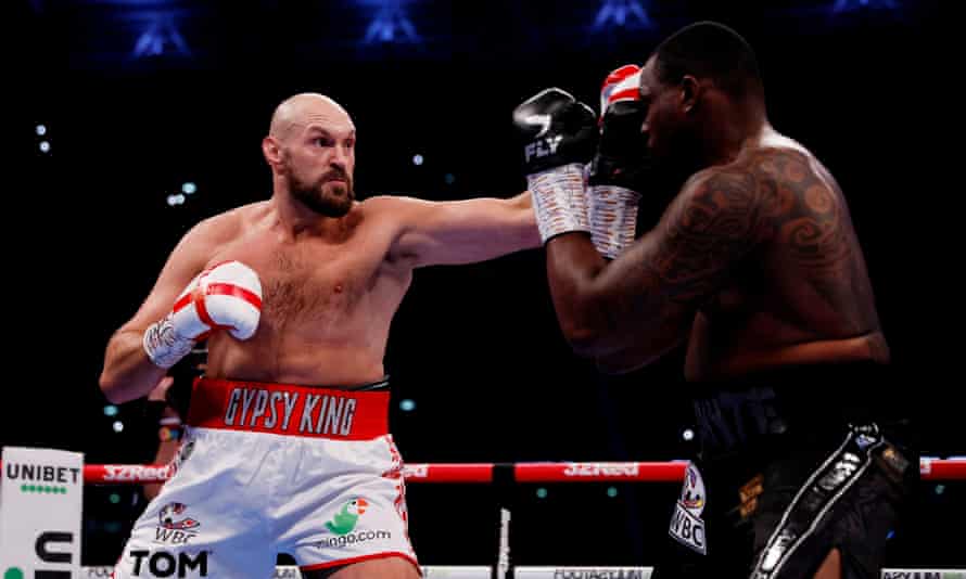 Tyson Fury throws a left towards Dillian Whyte during the opening round.