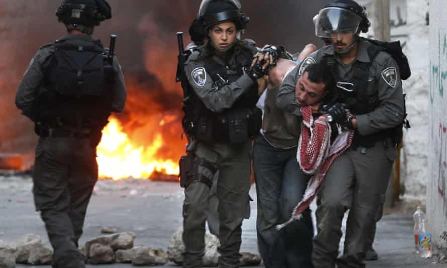 Israeli security forces arrest a Palestinian during clashes in the Palestinian neighbourhood of Shuafat in east Jerusalem as violence spiked in east Jerusalem and the occupied West Bank. 