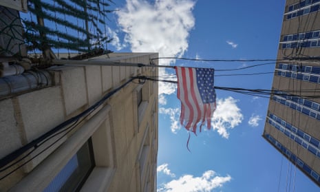 A tattered American flag hangs from a fence across the street from Wyckoff Hospital (R) in the Borough of Brooklyn, new york