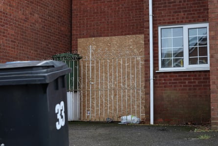 A board of plywood against the wall of the property.