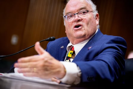 a man speaking in front of a microphone