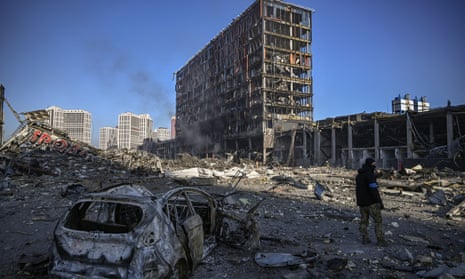 A Ukranian serviceman walks between debris outside the destroyed Retroville shopping mall in a residential district after a Russian attack on the Ukranian capital Kyiv on March 21, 2022.