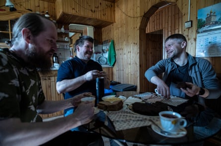 Father Soldatenko and Ianenkov sit and eat with Alex, who occasionally attends and works at the Russian base.