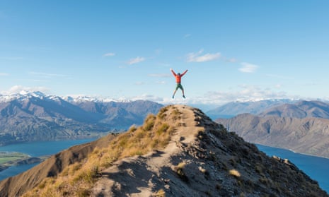 Man jumping on top of NZ mountain