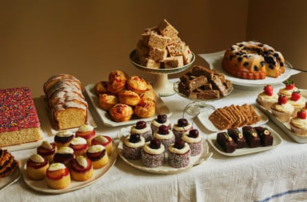 Table covered in plates holding assorted cakes and pastries