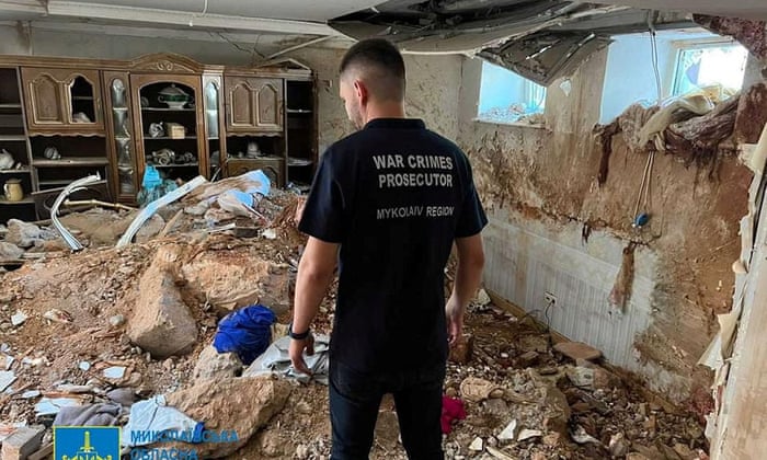 A war crimes prosecutor examines the damage in a destroyed building, as Russia’s attack on Ukraine continues, following shelling in Mykolaiv, Ukraine, on 31 July.