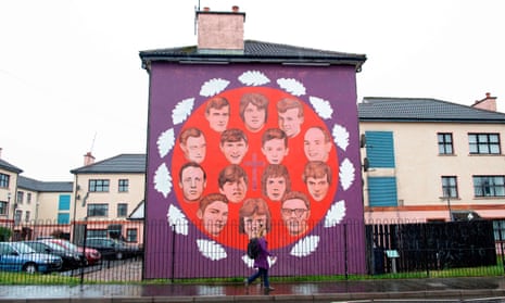 A pedestrian walks past a mural honouring the victims of the 1972 Bloody Sunday killings in Derry.