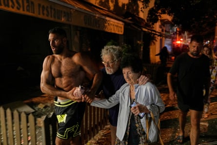 People evacuate after a missile struck Tel Aviv, Israel.