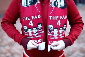 A Liverpool fan proudly displays a scarf before the match against Swansea City