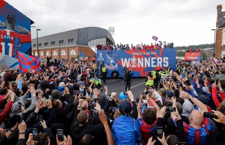 The bus carrying the Crystal Palace players and staff pass by their home ground at Selhurst Park during the FA Cup winners parade.