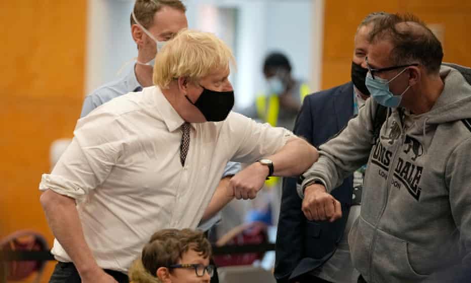 Boris Johnson attends a Covid vaccination centre in London at the launch a national campaign to encourage the public to accept their booster jabs