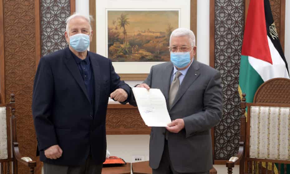 Palestinian president Mahmoud Abbas (R) signs the decree for holding parliamentary and presidential elections on May 22 and July 31, respectively, after meeting with chairman of the Palestinian central elections commission Hanna Nasser (L) in Ramallah, West Bank