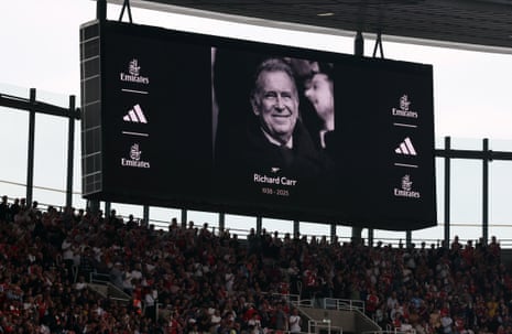 General view of the big screen during a minutes applause in memory of Richard Carr before the match.