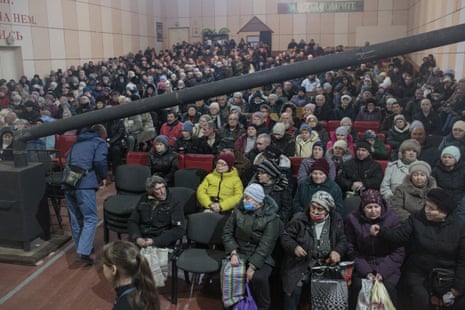 People at a distribution of humanitarian aid in the theatre building at Ark of Salvation Church, in Kramatorsk, Ukraine.