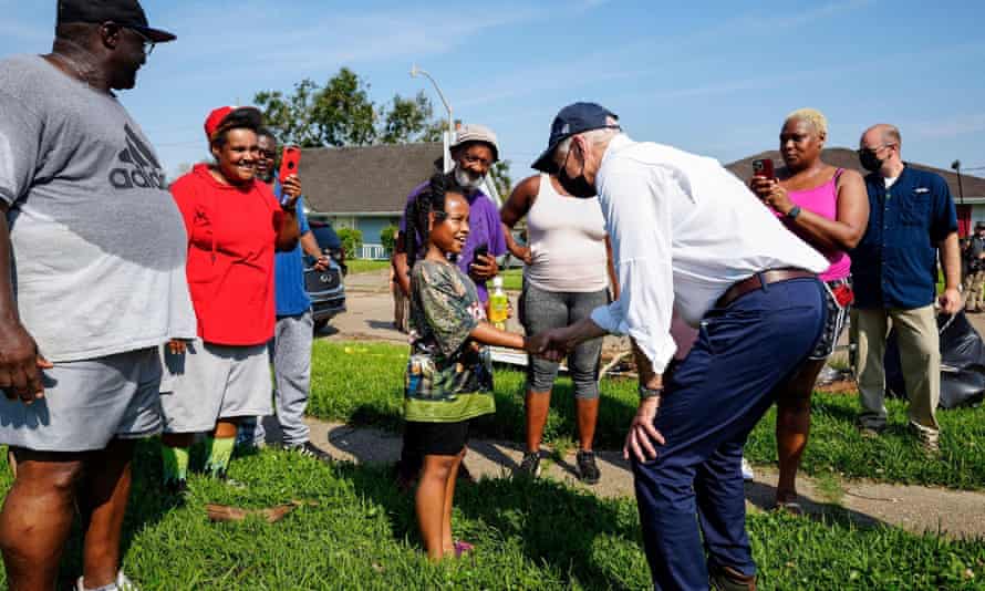 Biden greets a young girl during a tour of areas damaged by Hurricane Ida in LaPlace, Louisiana, September 2021.