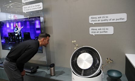 An employee demonstrates home appliances that can be controlled by Amazon Alexa at the LG booth during CES.