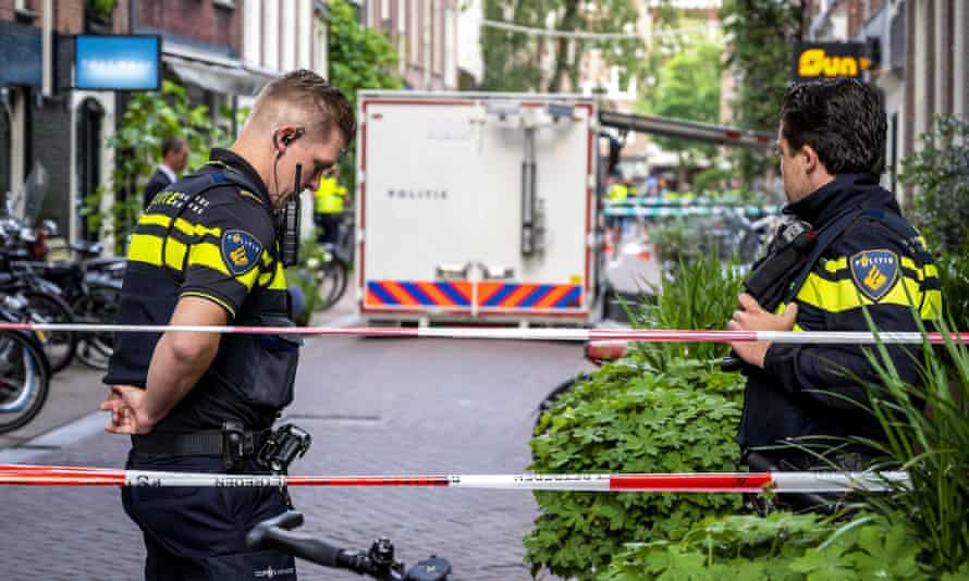 Police at the site of the Amsterdam shooting in July 2021 of investigative journalist Peter R de Vries, who later died of his injuries.