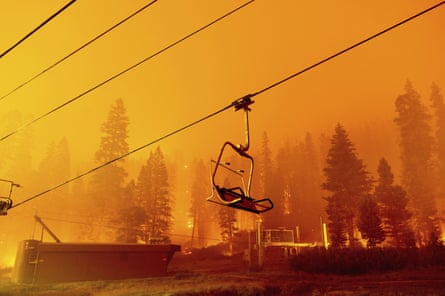 The Caldor Fire burns as a chair lift sits at the Sierra-at-Tahoe ski resort.