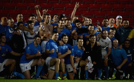 Italy players and staff celebrate after the 15-14 victory.