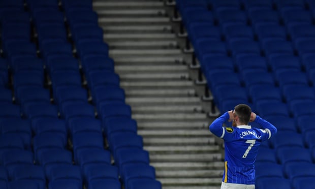 Aaron Connolly of Brighton celebrates in front of empty stands after scoring against Wolves