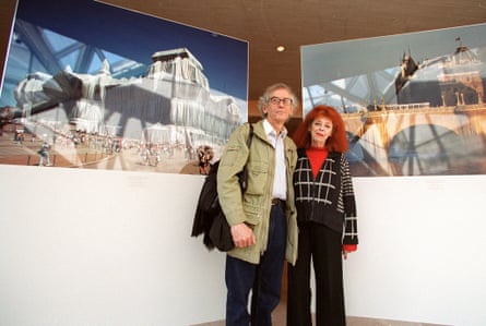 Christo and Jeanne-Claude at the National Gallery of Art in Washington in 2002 with photographs of some of their work.