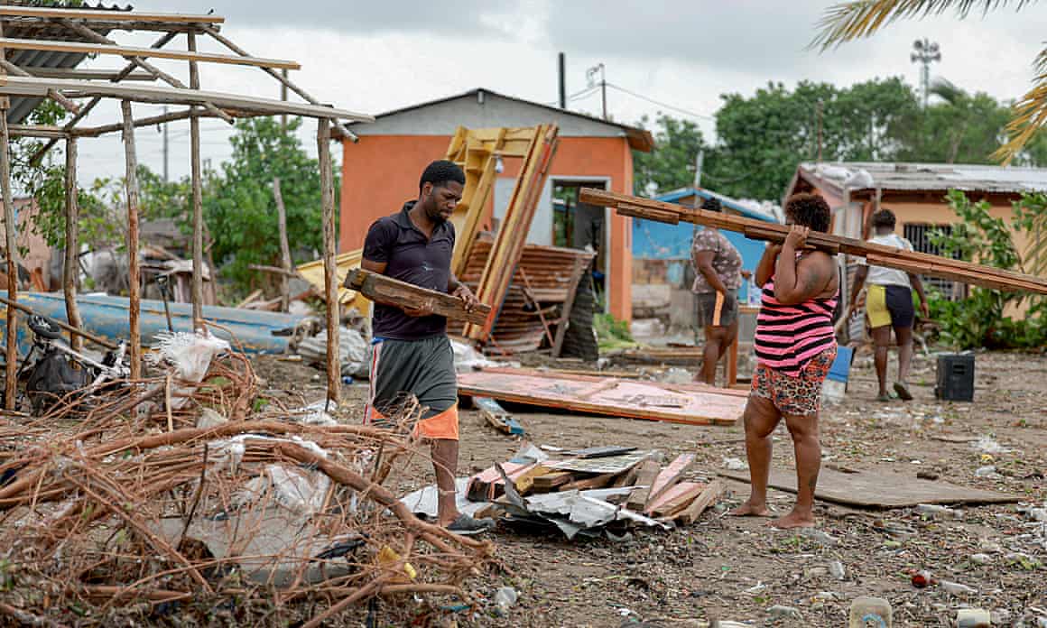 Omar Soloman and Keysha Hill survey the wreckage of Soloman’s shop