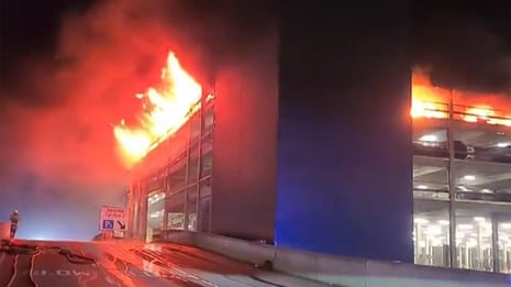 Flames engulf London's Luton airport multistorey car park – video report