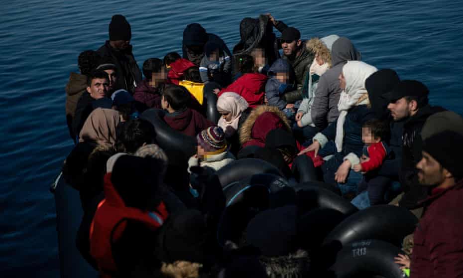 Migrants, who crossed part of the Aegean Sea from Turkey, are seen on a dinghy with a damaged engine, as locals prevent them from docking at the port of Thermi, on island of Lesbos, Greece.