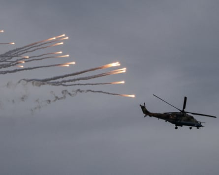 Belarusian Mi-35 attack helicopter with missiles flying behind it