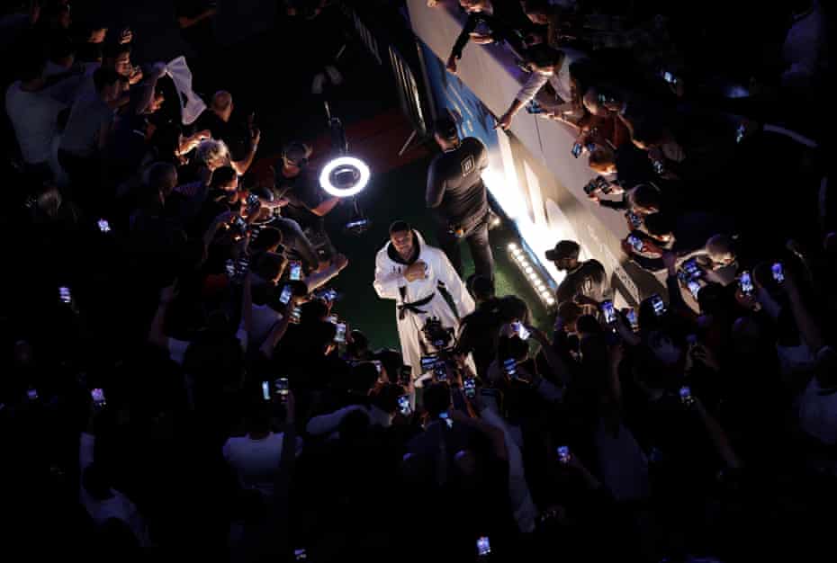 Anthony Joshua taps his heart with his glove as he enters the arena before taking on Oleksandr Usyk in their World Heavyweight title boxing fight at the Tottenham Hotspur Stadium on September 25th 2021.