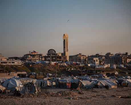 tents with buildings behind them