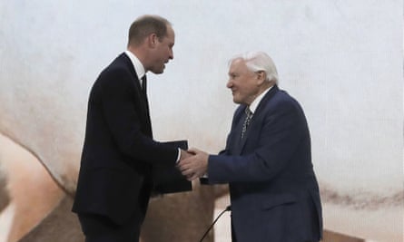 Prince William greets Sir David Attenborough on stage at Davos.