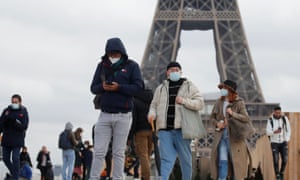 People seen on Trocadero square near the Eiffel Tower in Paris on 6 December as France considers more drastic measures to fight a surge in Covid-19 infections.