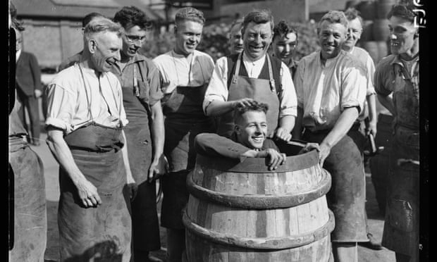 An apprentice cooper readies for an initiation ceremony at the brewery, then owned by the Watney family, in 1934.