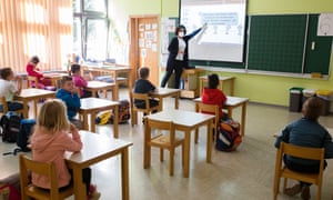 Pupils learn about physical distancing at a reopened school in Kranj, Slovenia