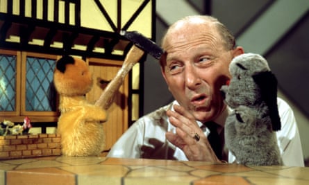 Harry Corbett, creator of The Sooty Show, during a show in 1968 with Sooty (with a hammer, left) and Sweep.