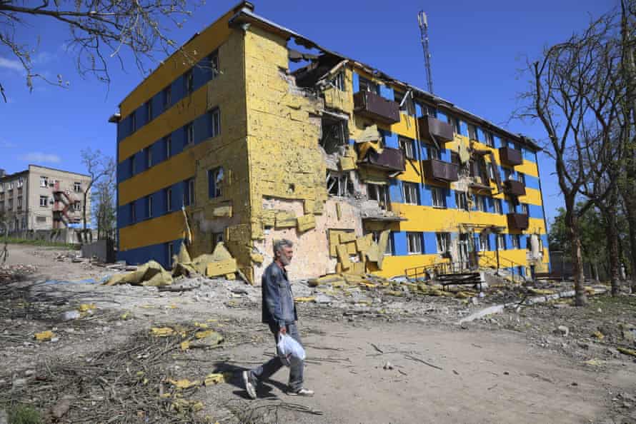 A man walks past a destroyed building in Mariupol, in territory under the government of the Donetsk People’s Republic, eastern Ukraine, on Friday.