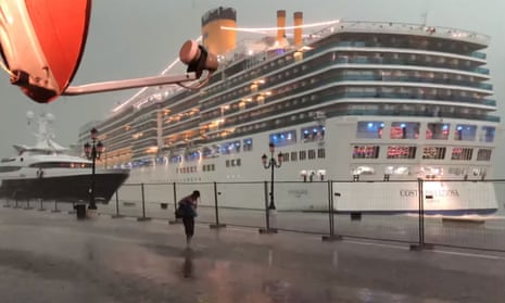 The cruise ship Costa Deliziosa sails dangerously close to a yacht in Venice during a thunderstorm on 8 July