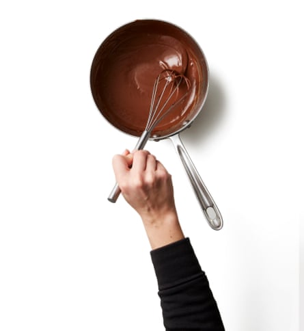 Stir the chocolate into the hot cream. Add the chocolate to the pan of hot cream and milk, then take it off the heat. Leave to sit for a minute or so, then stir vigorously until the chocolate melts into the cream and there are no lumps or dark streaks visible – it should look like smooth hot chocolate. Set aside.